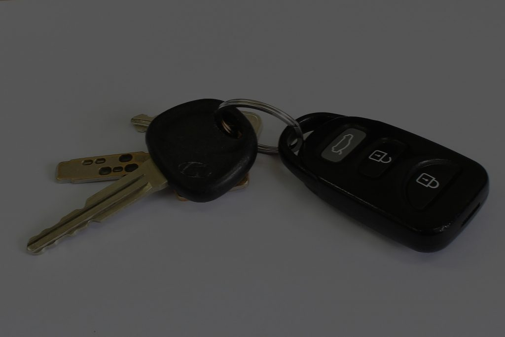 Car keys with an electronic remote, resting on a flat surface. The image highlights essential items for unlocking and starting a vehicle.