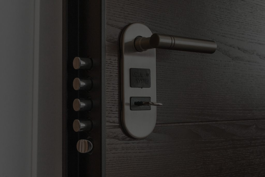 Close-up of a modern door lock featuring a metallic handle and a key inserted. It highlights security features for residential access.